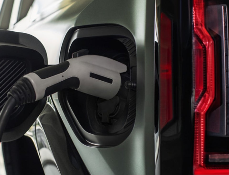 Close up of charging port with charger plugged in on a GMC Hummer EV SUV - Marshall Chevrolet GMC in Jerseyville IL